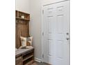 Mud room with wood bench, storage, coat hooks, and decor at 2851 Fareed St, Douglasville, GA 30135