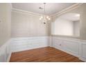 Bright dining area with hardwood floors, decorative molding, and elegant lighting at 11151 Aliyah Dr, Hampton, GA 30228