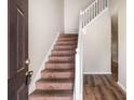 Inviting entryway with a staircase, featuring modern flooring and neutral wall paint at 11151 Aliyah Dr, Hampton, GA 30228