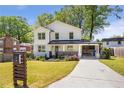 Inviting two-story home with a freshly painted exterior, charming front porch, and driveway at 1934 Westwood Sw Ave, Atlanta, GA 30310