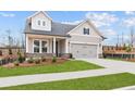 Charming home featuring a two-car garage, well-kept lawn and traditional architectural details at 214 Strawberry Ln, Woodstock, GA 30189