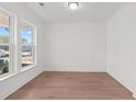 Bright living room featuring hardwood floors and a large window with natural light at 214 Strawberry Ln, Woodstock, GA 30189