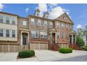 Attractive townhomes featuring brick and stone facades, front entry garages, and stairways at 346 Ardmore Ct, Atlanta, GA 30309