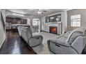 Spacious living room with a fireplace, hardwood floors, and comfortable seating, perfect for entertaining and relaxation at 1510 Silver Mist Cir, Powder Springs, GA 30127