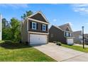Two-story home with attached two-car garage and a lush green lawn at 224 Eva Way, Cartersville, GA 30121