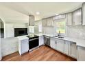 Modern kitchen featuring stainless steel appliances, gray cabinetry and tiled backsplash at 534 534 Shannon Way, Lawrenceville, GA 30044