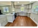 Modern kitchen featuring stainless steel appliances, gray cabinetry and tiled backsplash at 534 534 Shannon Way, Lawrenceville, GA 30044