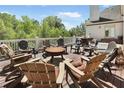 Outdoor deck features a fire pit with ample seating and wooded views at 560 Brook Manor Dr, Johns Creek, GA 30022