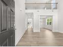 Open-concept living area featuring a second-story balcony, and light wood flooring at 7162 Linden Dr, South Fulton, GA 30349
