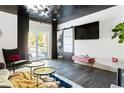 Chic bonus room with dark ceiling and sliding glass doors to the backyard at 1984 Yellow Finch Se Trl, Atlanta, GA 30316