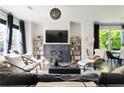 Bright living room features a fireplace, stylish decor, and large windows at 1984 Yellow Finch Se Trl, Atlanta, GA 30316