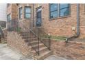 Brick stairs lead up to a wrought iron security door and entrance of townhome at 683 Pryor Sw St # C, Atlanta, GA 30315