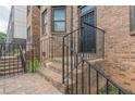 Brick stairs lead up to a wrought iron security door and entrance of townhome at 683 Pryor Sw St # C, Atlanta, GA 30315