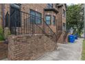 Brick townhome with stairs that lead to the wrought iron security door entrance at 683 Pryor Sw St # C, Atlanta, GA 30315