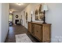 Spacious foyer with hard surface flooring, console table and decor leading to the living room at 255 Eason Ave, Bowdon, GA 30108
