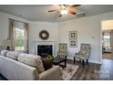 Inviting living room featuring a cozy fireplace, comfortable seating, and ample natural light at 255 Eason Ave, Bowdon, GA 30108