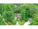 Aerial view of the two-story home surrounded by lush greenery and mature trees at 210 Malvern Pl, Roswell, GA 30076