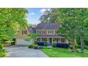 Charming two-story home featuring a welcoming front porch and beautifully landscaped front yard at 210 Malvern Pl, Roswell, GA 30076