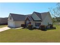 View of house exterior showing manicured lawn, bushes and clean trim at 502 Owens Springs Ln, Mcdonough, GA 30252