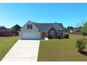 Well maintained single Gathering house showing driveway, lawn, trees and bushes at 502 Owens Springs Ln, Mcdonough, GA 30252