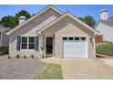 Charming single-story brick home boasts a well-manicured front yard and an attached one-car garage at 123 Stoneforest Dr, Woodstock, GA 30189