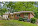Side view of a brick home with well-maintained landscaping, large windows and an attached carport at 1460 Briarcliff Ne Rd, Atlanta, GA 30306