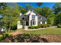 Beautiful two-story home with a lush front lawn, manicured bushes, and a driveway at 1820 Lyon Sw Ave, Atlanta, GA 30331