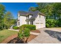 View of the rear of the house, highlighting an attached garage with an extra-long driveway at 1820 Lyon Sw Ave, Atlanta, GA 30331