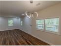 Bright living room featuring hardwood floors, modern lighting, and ample natural light at 214 Adeline Nw Ave, Atlanta, GA 30314