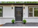 Striking front door with modern lighting and landscaping, inviting you to discover the beauty within at 2554 Gordon Se Cir, Smyrna, GA 30080