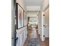 Inviting hallway with hardwood floors, decorative wall trim, and an open view to the spacious living room at 26 Kensington St, Kingston, GA 30145