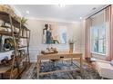 Home office with large window, neutral walls, decor, and built in shelving unit at 26 Kensington St, Kingston, GA 30145