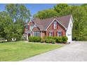 Attractive brick home with red shutters, green lawn and attached garage at 2945 Barimore Pl, Dacula, GA 30019