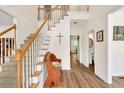 Inviting foyer with staircase, hardwood floors, and elegant decor at 2945 Barimore Pl, Dacula, GA 30019