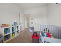 Bright, cozy bedroom featuring a playful bookcase and plush crib with colorful decor at 3203 Cyrus Point Nw Ln, Kennesaw, GA 30152