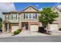 Charming townhome with a brick facade, attached garage, and well-maintained landscaping at 3203 Cyrus Point Nw Ln, Kennesaw, GA 30152