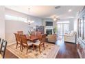 Open-concept dining room with hardwood floors and chandelier lighting at 4236 Tacoma Trce, Suwanee, GA 30024