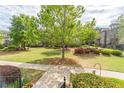 Beautifully landscaped front yard with lush green grass and mature trees at 4236 Tacoma Trce, Suwanee, GA 30024