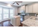 Modern kitchen features stainless steel appliances, granite countertops, and a center island at 4236 Tacoma Trce, Suwanee, GA 30024