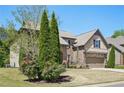 Attractive home showcasing lush landscaping with mature trees and blooming bushes at 6565 Bentley Ridge Dr, Cumming, GA 30040