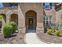 Inviting front entrance with stone accents and a charming front door at 6565 Bentley Ridge Dr, Cumming, GA 30040
