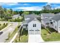 Two-story home with white siding and two car garage surrounded by green grass at 1304 Six Sisters St, Dacula, GA 30019