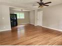 Open concept living room featuring hardwood floors, neutral paint, and plenty of natural light at 4030 Hiram Ct, Powder Springs, GA 30127