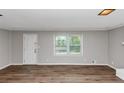 Bright, empty living room with hardwood floors, freshly painted walls, and natural light at 4261 Autumn Hill Dr, Stone Mountain, GA 30083