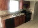 Close up of kitchen with black dishwasher and range and tile backsplash at 432 Rock Meadow Dr, Stone Mountain, GA 30088