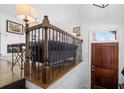 Inviting entryway featuring hardwood floors, dark wood door, and an iron railing at 64 Emerson Hill Sq, Marietta, GA 30060