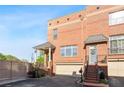 Charming brick townhouse with covered porch, stairs to the front door, and two car garage at 64 Emerson Hill Sq, Marietta, GA 30060