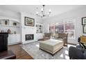 Bright living room with hardwood floors, fireplace, built-in shelving, and large windows at 64 Emerson Hill Sq, Marietta, GA 30060