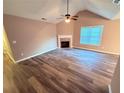 Bright living room boasts high ceilings, a cozy fireplace, and beautiful new hardwood floors at 11447 Vinea Ln, Hampton, GA 30228