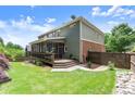 Spacious backyard with a screened porch, beautiful lawn, and wooden fence at 1286 Whisper Cove Dr, Buford, GA 30518